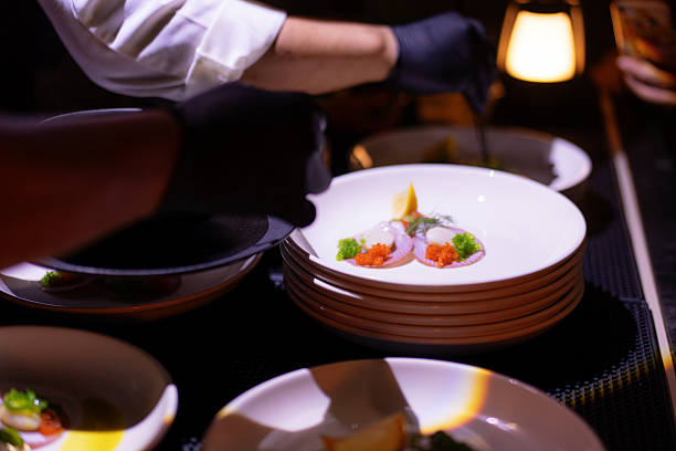 istock Chef Drizzling Yellow Sauce Over a Gourmet Scallop Appetizer 2235662091