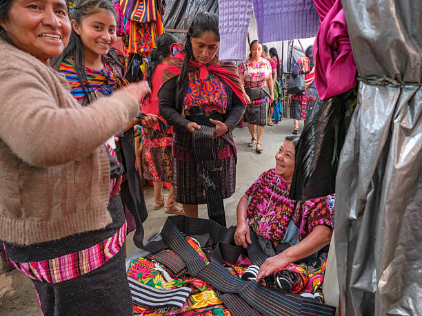 Chichicastenango, Guatemala - July 3, 2025: Women shopping for traditional clothing at the Santo Tomas Market in Chichicastenango, Guatemala.