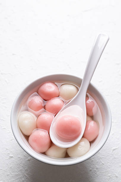 istock Tangyuan (Chinese sweet dumpling), Pink glutinous rice ball in syrup on white background 2235665233