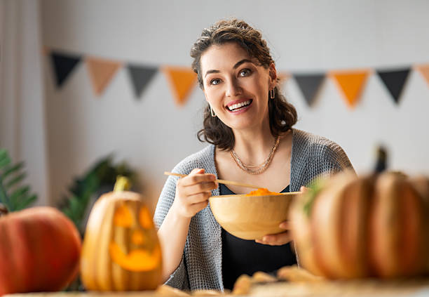 istock woman is carving pumpkin 2235667288