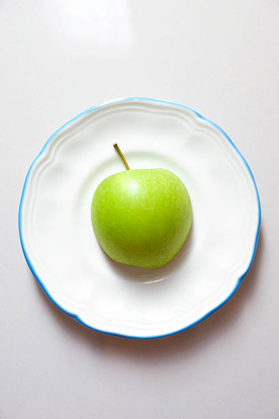 Close-up of a green apple on a plate