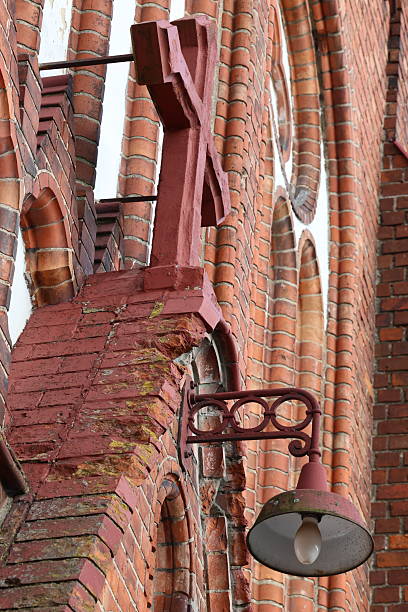 istock Brickwork Architectural Detail with Decorative and religious Elements - holy cross and lamp 2235679993