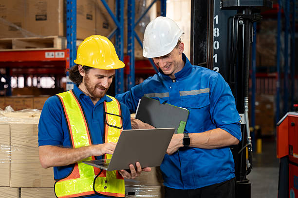 istock Logistics team reviewing data together on a laptop during a warehouse shift. The interaction emphasizes real-time planning, inventory control, and smooth coordination in modern supply chain work. 2235684470