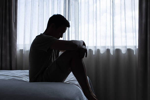istock Lonely hopeless man in dark bedroom dealing with depression feeling emotional. 2235686731