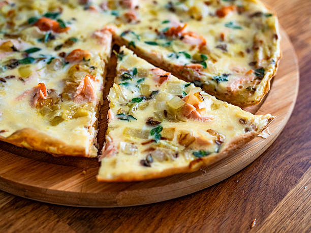 istock Frittata - scrambled eggs with roasted salmon bites, fried onion and fresh thyme on wooden table 2235687818