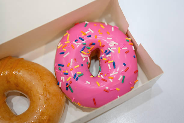 Donuts, sweet snack with various topping which are prepared for sale at the bakery shop. Sweet food object photo.