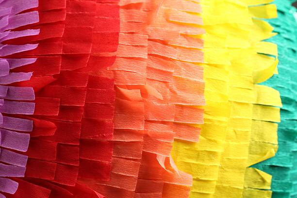 istock Pinata. Cut tissue paper in different colors as background, closeup 2235688552