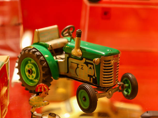 Plastic toy bulldozer isolated on a white background.