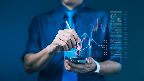 istock Businessman using stylus on smartphone with rising stock chart for mobile trading and real-time financial performance analysis 2235690225