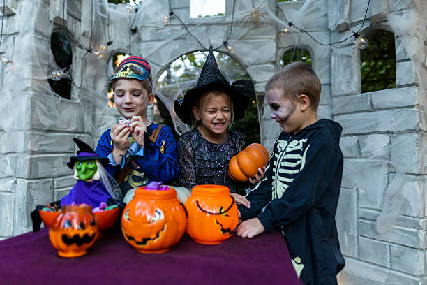 istock Children celebrating Halloween outdoors at night. 2235690504