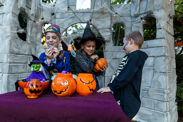 istock Children celebrating Halloween outdoors at night. 2235690505