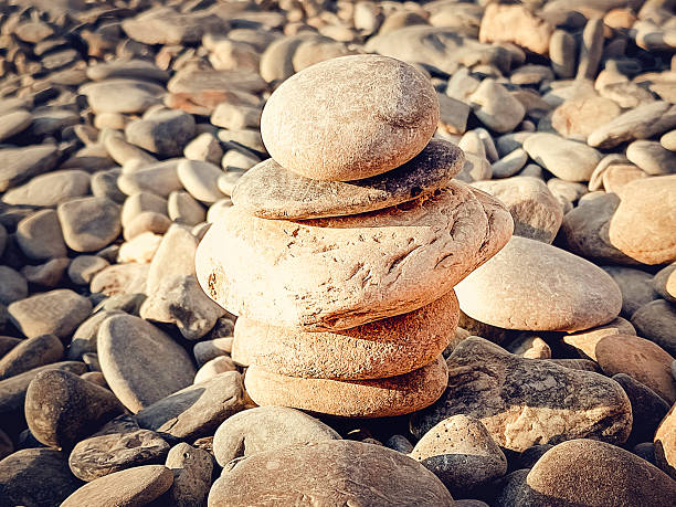 Tower of sea pebbles on the seashore. Calm background,