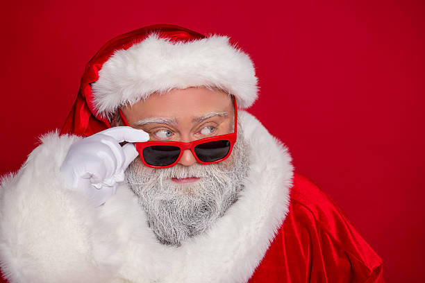 istock Portrait of attractive funny curious Santa touching specs north pole thinking deciding isolated over vivid red color background 2235691345