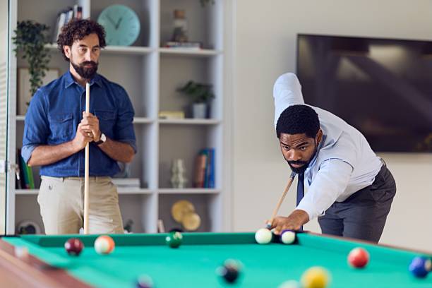 istock Two Men Engaging in a Competitive Game of Pool in a Relaxed Setting 2235691408