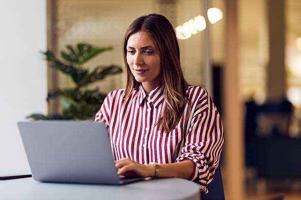 istock Professional Woman Working on Laptop at Modern Office Workspace 2235691411
