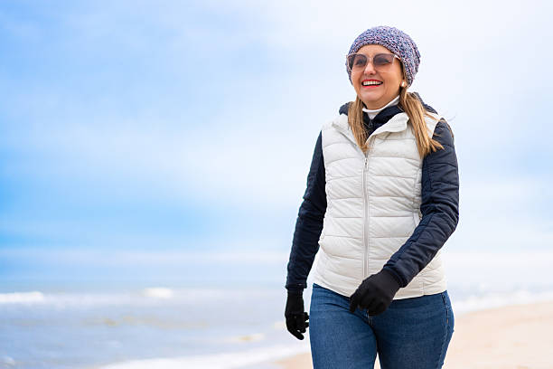 Mid adult woman exercising on beach