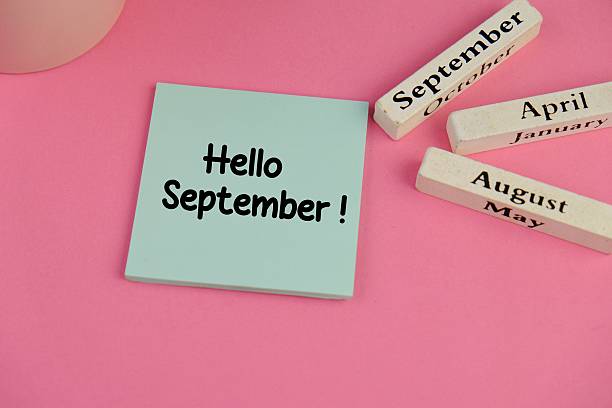 istock Hello September written on blue paper on pink table at teacher or student workplace. Back to school time 2235693609