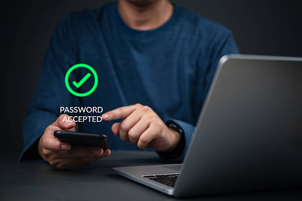 istock Security, Password Hands holding smartphone show password accepted next to laptop in home office to complete login, illustrating strong 2FA, OTP, and data protection concept. 2235693902