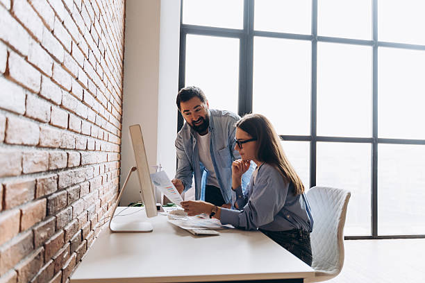 istock Business partners discussing marketing strategy using computer and documents in modern office 2235694339