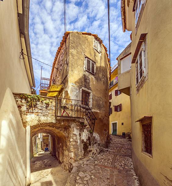 Rustic cobbled alley with historic stone houses in the old town of Vrbnik on Krk island Croatia