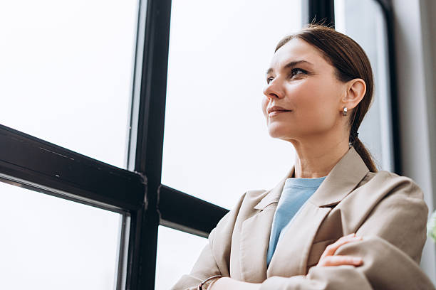 istock Businesswoman looking out the window and thinking about future projects 2235695212