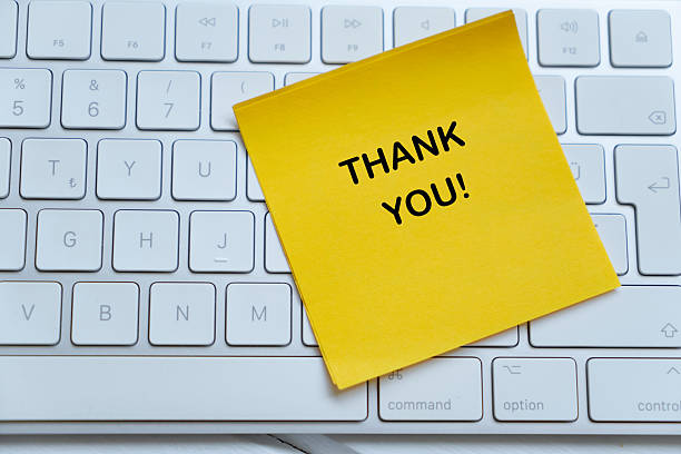 istock Keyboard and Thank You Sticky Note 2235695529