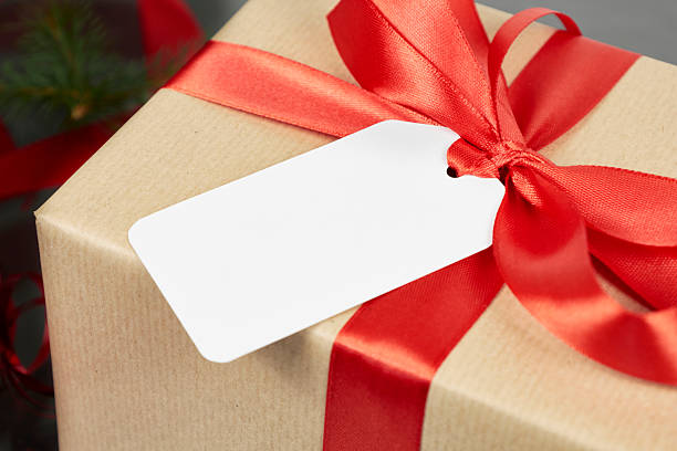 istock christmas gift box with red ribbon and blank white gift tag or name tag 2235698935