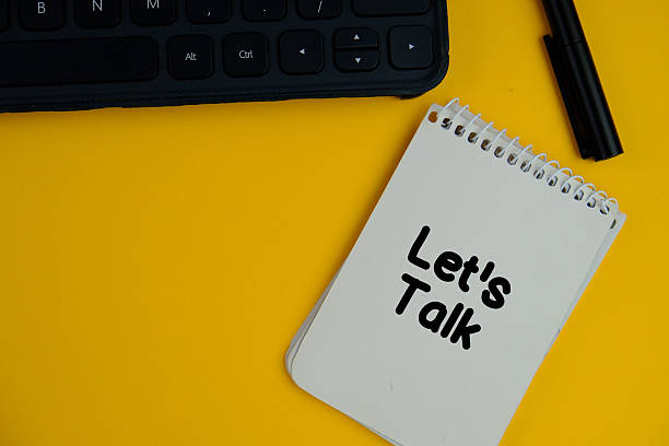istock Top view image of white notebook with text LET'S TALK on blue background with copy space. 2235699548