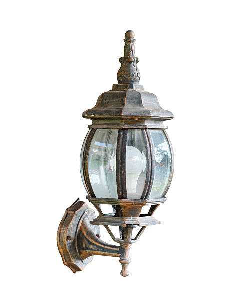 Vintage wall lamp with antique bronze finish, glass cover, and decorative design, isolated on white background.