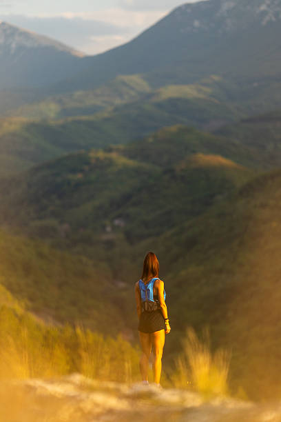istock Hiker Enjoying a Scenic Mountain View During Sunset in Nature 2235703697