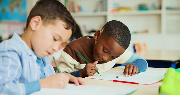 istock Learning, students and friends in classroom for creative, test and art assignment or study. Kids, pencil and coloring in lesson for children, education and project for development together at school 2235704591