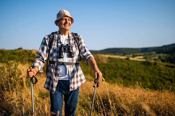 istock Smiling retired hiker with backpack and hiking poles in nature 2235704914
