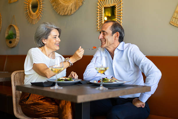 istock Happy senior couple enjoying a romantic dinner date at a restaurant 2235705039