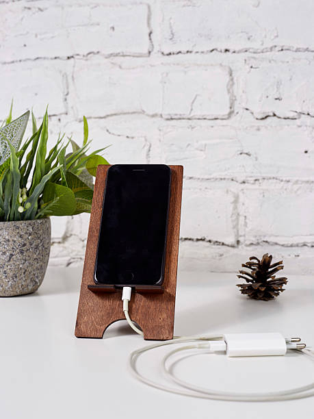 istock smartphone in wood stand on light wooden table 2235705351