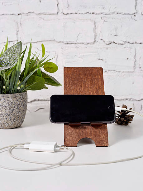 istock smartphone in wood stand on light wooden table 2235705372