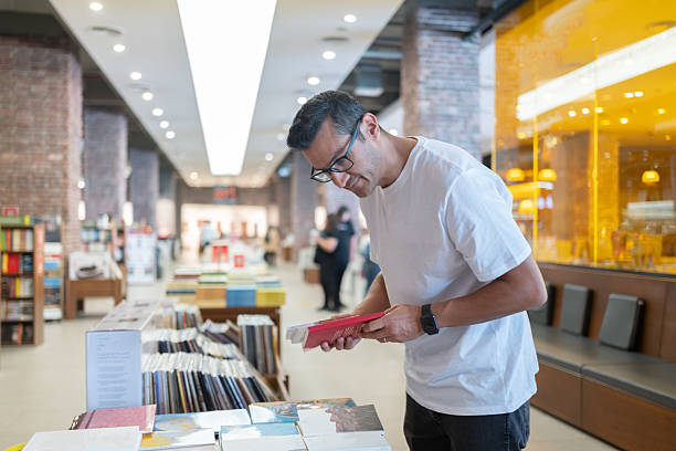 Man Choosing Books In Bookstore