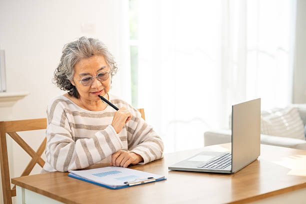 istock Asian senior woman using laptop at home. 2235707392