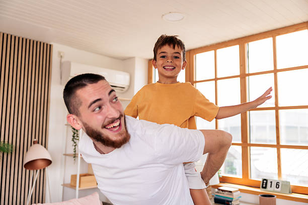istock Playful father and son having fun while piggybacking 2235707435