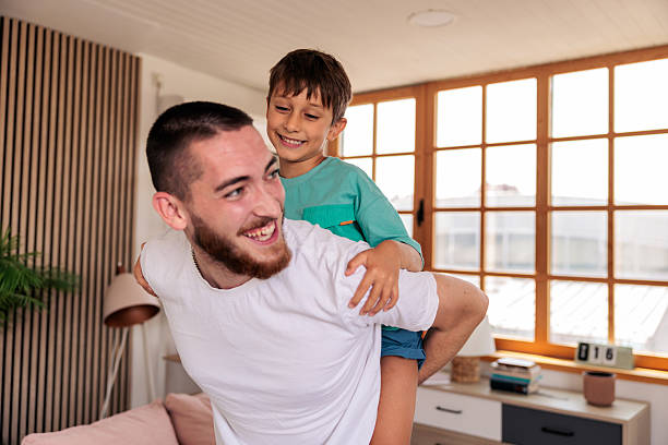 istock Playful father and son having fun while piggybacking 2235707445