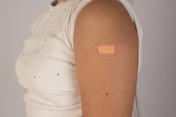istock a person's arm with a band-aid, indicating a recent injection or minor wound 2235708113