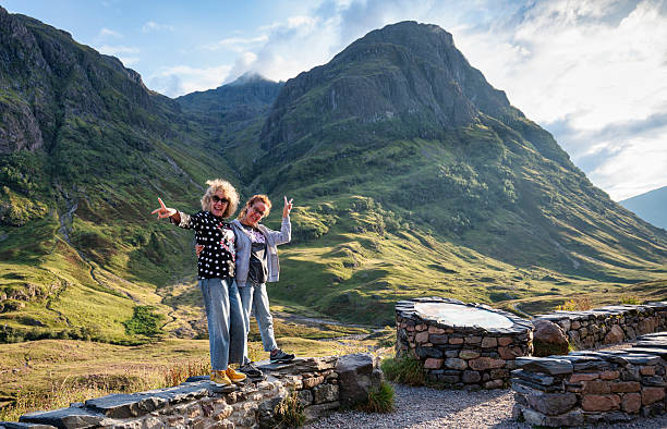 Two middle-aged sisters smiling and posing in Glencoe Highlands