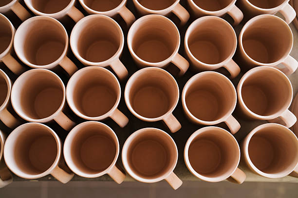 Workers decorate porcelain cups at a ceramics factory in Jingdezhen, China.