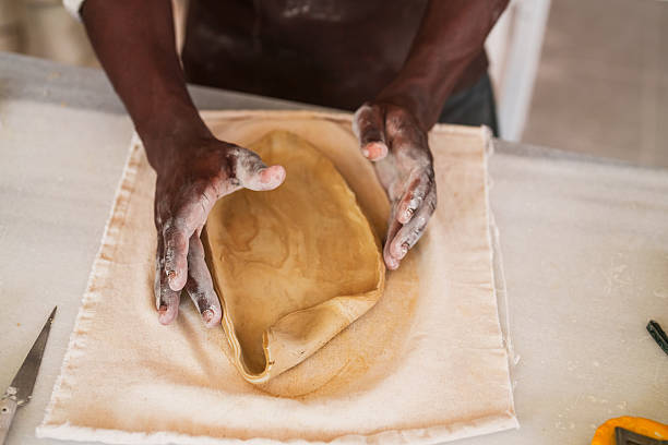 istock Shaping Clay Slab into Form in Pottery Studio 2235709679
