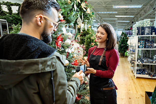 istock Customer paying contactless in Christmas shop with staff help 2235710268