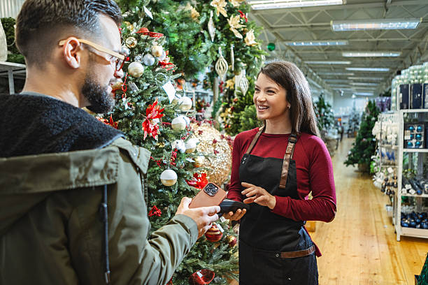 istock Customer service in festive gift shop with card payment 2235710270
