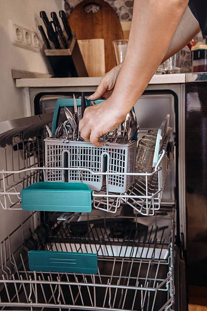 istock Loading dishwasher with cutlery and glasses 2235713104