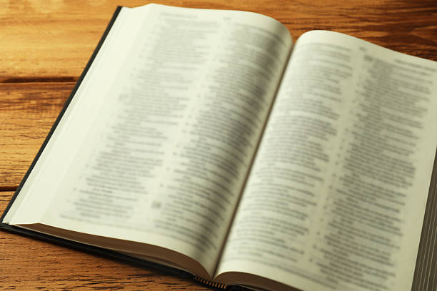 istock Open Holy Bible in English language on wooden table, closeup 2235713721