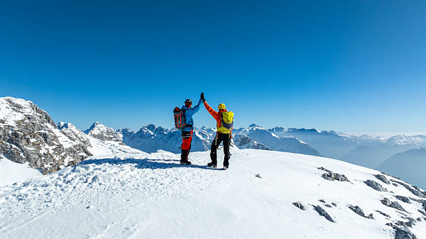istock Climbers Celebrating Achievement on Snowy Peak 2235714172