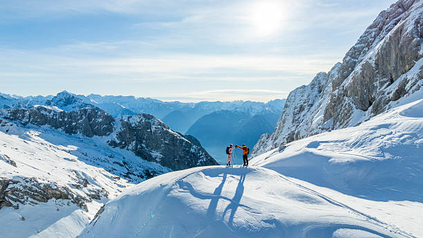 istock Ski Mountaineers Navigating Alpine Ridge at Sunrise 2235714178