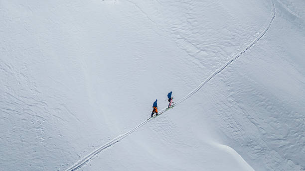 istock Adventurers Traversing Snowy Ridge at Dawn 2235714183